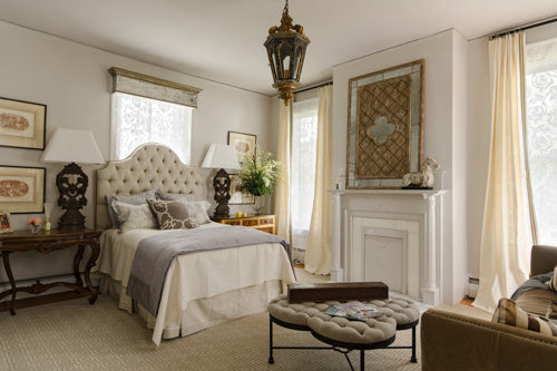 Luxurious bedroom with a bed, lampshades, and decorative items.